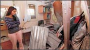 Frustrated Israeli inspects the damage to her home hit by a Hamas rocket in Southern Israel last month. Photo: Eddie Israel/Israel Sun