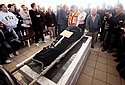 Mourners at the funeral of 58 year old Beber Vaknin who was killed by shrapnel from a Grad rocket in the southern town of Netivot. Police officer is seen through the hole the Grad missile made in the late  Beber Vaknin's bedroom. Photo: Emil Salman/Jinipix/Israel Sun
