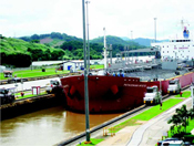A ship narrowly passes through Panama Canal at Miroflores Locks.